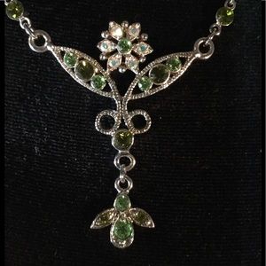 Delicate Angles with beautiful green stones.